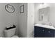 Stylish half-bathroom featuring a blue vanity, modern fixtures, and charming decor at 837 Porches Way, Dacula, GA 30019
