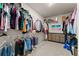 Spacious walk-in closet with ample storage, featuring wire shelving and a neutral color palette at 837 Porches Way, Dacula, GA 30019