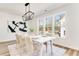 Bright dining room with a large window and a modern chandelier, perfect for gatherings at 919 East Green Ln, Clarkston, GA 30021