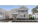 Charming two-story home with gray siding, a covered front porch, and manicured landscaping at 919 East Green Ln, Clarkston, GA 30021