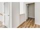 Hallway with wood floors and a doorway, providing access to various rooms at 919 East Green Ln, Clarkston, GA 30021