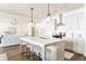 Bright, white kitchen featuring an island with bar seating and stainless steel appliances at 919 East Green Ln, Clarkston, GA 30021
