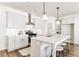 Modern kitchen with white cabinets, stainless steel appliances, and a large center island at 919 East Green Ln, Clarkston, GA 30021