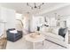 Bright, open living room with modern furniture, hardwood floors, and seamless flow at 919 East Green Ln, Clarkston, GA 30021