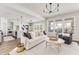 Open living and dining area with hardwood floors, modern decor, and abundant natural light at 919 East Green Ln, Clarkston, GA 30021