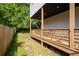 Cozy backyard featuring a wooden deck, grass, and a charming wooden fence providing privacy at 210 Locust Ne St, Atlanta, GA 30317