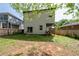 Backyard with a grassy area, a wooden fence, and the back exterior of the home at 210 Locust Ne St, Atlanta, GA 30317