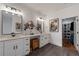 Double vanity bathroom with stone floors, elegant lighting and view to walk in closet at 210 Locust Ne St, Atlanta, GA 30317