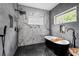 Luxury bathroom featuring a freestanding tub, modern fixtures, and marble-style tile at 210 Locust Ne St, Atlanta, GA 30317