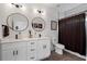 Modern bathroom featuring double vanity, quartz countertops, and round mirrors at 210 Locust Ne St, Atlanta, GA 30317