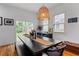Charming dining area with a modern light fixture and sliding glass doors leading to the backyard at 210 Locust Ne St, Atlanta, GA 30317