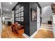 Elegant entryway with dark walls, wooden floors, and curated artwork leading to a bright staircase at 210 Locust Ne St, Atlanta, GA 30317