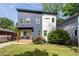 Charming two-story home with a modern design, landscaping, and a welcoming front porch at 210 Locust Ne St, Atlanta, GA 30317