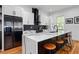Modern kitchen with island, white cabinets, black hardware, and stainless steel refrigerator at 210 Locust Ne St, Atlanta, GA 30317