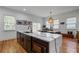 Modern kitchen with island and stainless steel microwave, with seamless access to the dining area at 210 Locust Ne St, Atlanta, GA 30317