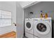 Laundry room featuring a front-load washer and dryer, and hardwood floors at 210 Locust Ne St, Atlanta, GA 30317