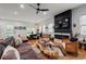 Open-concept living room featuring hardwood floors, a modern fireplace, and a dining area, perfect for modern living at 210 Locust Ne St, Atlanta, GA 30317