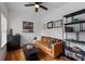 Cozy living room featuring hardwood floors, leather sofa, and decorative shelving at 210 Locust Ne St, Atlanta, GA 30317