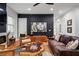 Inviting living room features hardwood floors, a dark accent wall, and a unique wood coffee table at 210 Locust Ne St, Atlanta, GA 30317