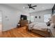 Spacious main bedroom with wood floors, large windows, TV, and a seating area at 210 Locust Ne St, Atlanta, GA 30317
