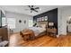 Spacious main bedroom with a black accent wall, ceiling fan, and hardwood floors at 210 Locust Ne St, Atlanta, GA 30317