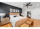 A view of the main bedroom showcasing a wooden bed, wood floors, and minimalist decor at 210 Locust Ne St, Atlanta, GA 30317