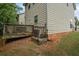 Backyard exterior featuring a small wooden deck and view of the house's siding at 7322 Bridlewood Ct, Jonesboro, GA 30236