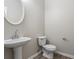 Cozy half bathroom featuring a pedestal sink, modern faucet, and neutral wall color creating a clean and fresh look at 7322 Bridlewood Ct, Jonesboro, GA 30236