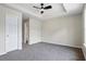 Comfortable bedroom highlighting plush carpeting, a ceiling fan, and a large window at 7322 Bridlewood Ct, Jonesboro, GA 30236