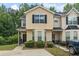 Charming townhome with a well-maintained lawn and a classic facade, accented by dark shutters and trim at 7322 Bridlewood Ct, Jonesboro, GA 30236