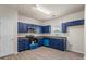 Well-appointed kitchen with painted cabinets, modern appliances, and light-toned wood-look flooring at 7322 Bridlewood Ct, Jonesboro, GA 30236