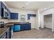 Kitchen with dark cabinets, light countertops, modern appliances, and wood-look floors, offering both style and functionality at 7322 Bridlewood Ct, Jonesboro, GA 30236