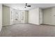 Spacious living room with neutral tones, plush carpeting, and large windows for abundant natural light at 7322 Bridlewood Ct, Jonesboro, GA 30236
