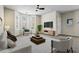 Stylishly decorated living room featuring a bay window, neutral decor, and modern furniture at 7322 Bridlewood Ct, Jonesboro, GA 30236