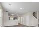Spacious living room featuring neutral walls, plush carpeting, and an open view into the kitchen area at 7322 Bridlewood Ct, Jonesboro, GA 30236