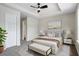 Stylishly furnished main bedroom featuring a ceiling fan and decor with a comfortable bed and ample lighting at 7322 Bridlewood Ct, Jonesboro, GA 30236