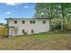 Backyard view of the white-brick two-story home, featuring a fenced yard at 130 Oakcliff Court, Atlanta, GA 30331