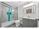 Modern bathroom with glass shower door, teal backsplash, and gray vanity at 130 Oakcliff Court, Atlanta, GA 30331