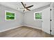Bedroom with natural light from windows, ceiling fan, and hardwood floors at 130 Oakcliff Court, Atlanta, GA 30331