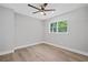 A minimalist bedroom with hardwood floors, ceiling fan and a window with green outdoor views at 130 Oakcliff Court, Atlanta, GA 30331