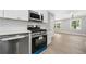 Modern kitchen with stainless steel appliances, white cabinets, and a view into the next room at 130 Oakcliff Court, Atlanta, GA 30331