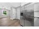 Bright kitchen with stainless steel refrigerator and open layout to adjacent living area at 130 Oakcliff Court, Atlanta, GA 30331