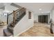 Basement stairs with wrought iron railing and a view of the finished space with decorative screen at 1922 Olde Village Run, Dunwoody, GA 30338