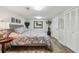 Bedroom with grey bedspread, wood floors, and closet with paneled doors at 1922 Olde Village Run, Dunwoody, GA 30338