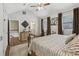 Vaulted bedroom with a ceiling fan, neutral carpet, and view to the ensuite bath and second floor landing at 1922 Olde Village Run, Dunwoody, GA 30338