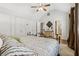 Vaulted bedroom with a ceiling fan, lots of storage, neutral carpet and a decorative wrought iron bed at 1922 Olde Village Run, Dunwoody, GA 30338