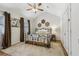 Vaulted bedroom with a ceiling fan, natural light, neutral carpet and a decorative wrought iron bed at 1922 Olde Village Run, Dunwoody, GA 30338
