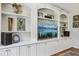 Detailed built-in shelving unit with white cabinets and arched top, perfect for storage and display at 1922 Olde Village Run, Dunwoody, GA 30338