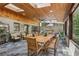 Bright sunroom with skylights features a long dining table for gathering and enjoying meals at 1922 Olde Village Run, Dunwoody, GA 30338