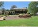 View of the rear exterior with large lawn and mature trees at 1922 Olde Village Run, Dunwoody, GA 30338